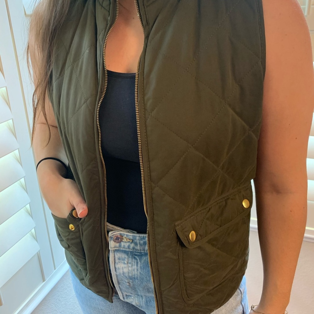Green puffer vest with gold accents
